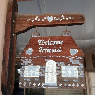 Welcome friends sign with solar powered wind chimes