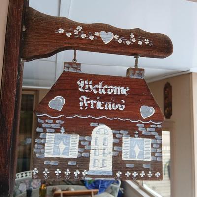Welcome friends sign with solar powered wind chimes