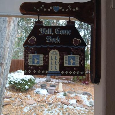 Welcome friends sign with solar powered wind chimes