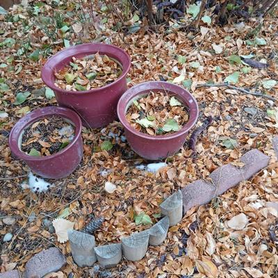 Three maroon ceramic flower pots
