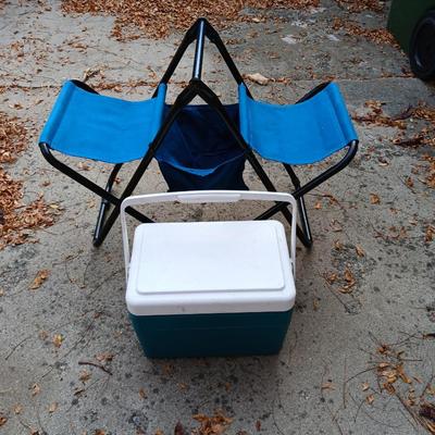 Folding bench with storage in center and a teal cooler
