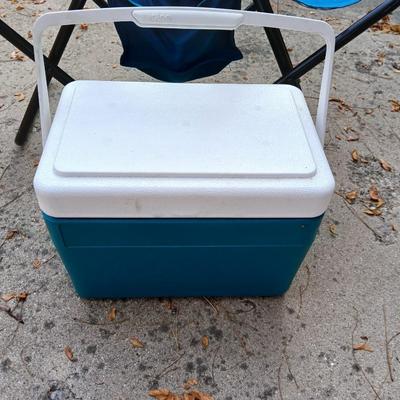 Folding bench with storage in center and a teal cooler