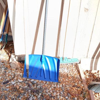 Yard tools - metal leaf rake, snow shovel, and a hard rake
