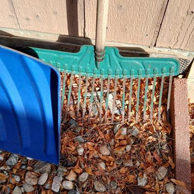 Yard tools - metal leaf rake, snow shovel, and a hard rake