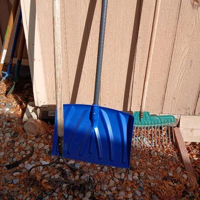 Yard tools - metal leaf rake, snow shovel, and a hard rake