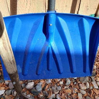 Yard tools - metal leaf rake, snow shovel, and a hard rake