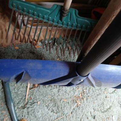 Yard tools - metal leaf rake, snow shovel, and a hard rake