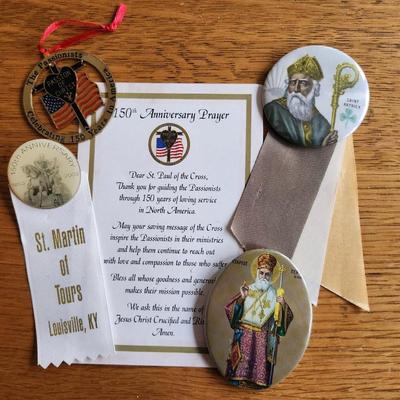 Sale Photo Thumbnail #282: This auction lot is for Badges, Pins and Ribbons with Religious Theme,  Contains a Medal and Card celebrating the 150th Anniversary of the Passionist religious in America, a St. Patrick Badge. a pin and ribbon celebrating the 150 years of St. Martin's Chu