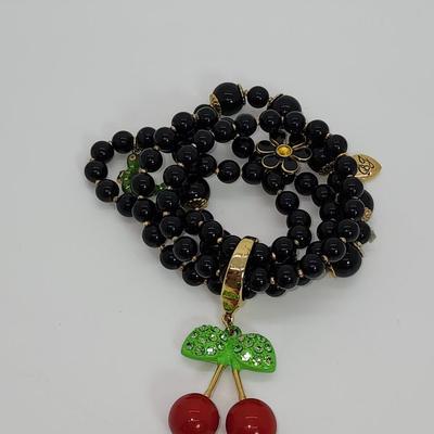LOT 5:: Betsey Johnson Multi bead Charm Bracelet featuring Cherries, flower and lil worm has her hangtag we included a jewelry satchel