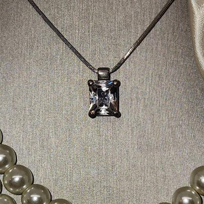 LOT 96:: Triple Strand Faux Glass Pearls with Accent Bow, Matching Bracelet and a Goldtone CZ Pendant Necklace by Express