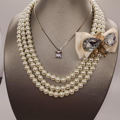 LOT 96:: Triple Strand Faux Glass Pearls with Accent Bow, Matching Bracelet and a Goldtone CZ Pendant Necklace by Express