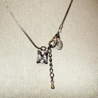 LOT 96:: Triple Strand Faux Glass Pearls with Accent Bow, Matching Bracelet and a Goldtone CZ Pendant Necklace by Express