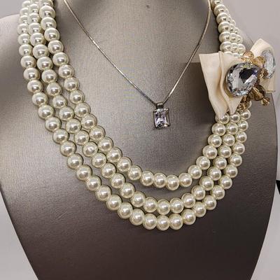 LOT 96:: Triple Strand Faux Glass Pearls with Accent Bow, Matching Bracelet and a Goldtone CZ Pendant Necklace by Express