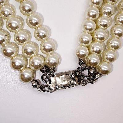 LOT 96:: Triple Strand Faux Glass Pearls with Accent Bow, Matching Bracelet and a Goldtone CZ Pendant Necklace by Express