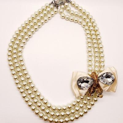 LOT 96:: Triple Strand Faux Glass Pearls with Accent Bow, Matching Bracelet and a Goldtone CZ Pendant Necklace by Express