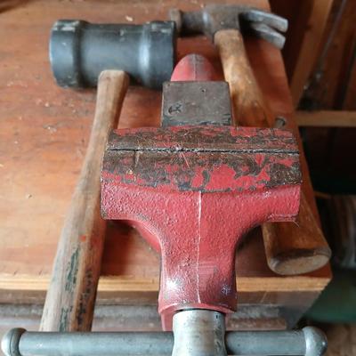 Small workbench mount vice with assortment of hammers