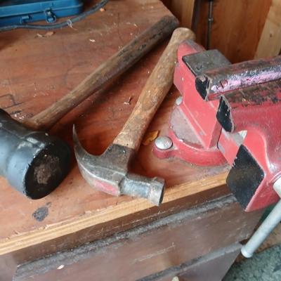 Small workbench mount vice with assortment of hammers