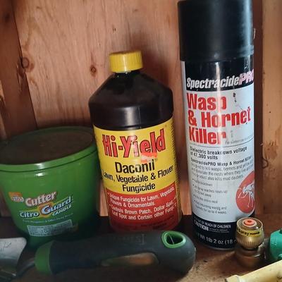 Yard & Garden tools and plant chemicals with potting spoil and a watering can