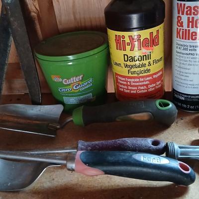 Yard & Garden tools and plant chemicals with potting spoil and a watering can