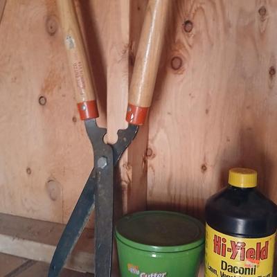 Yard & Garden tools and plant chemicals with potting spoil and a watering can