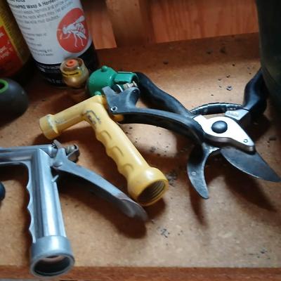Yard & Garden tools and plant chemicals with potting spoil and a watering can