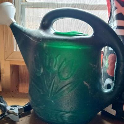 Yard & Garden tools and plant chemicals with potting spoil and a watering can