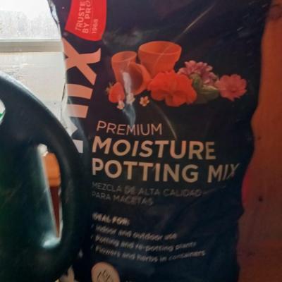 Yard & Garden tools and plant chemicals with potting spoil and a watering can