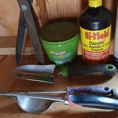 Yard & Garden tools and plant chemicals with potting spoil and a watering can