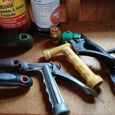 Yard & Garden tools and plant chemicals with potting spoil and a watering can