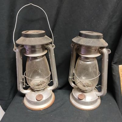 Two vintage kerosene lanterns adapted with solar lights
