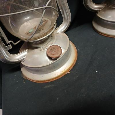 Two vintage kerosene lanterns adapted with solar lights