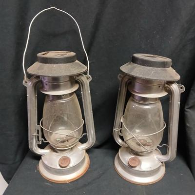 Two vintage kerosene lanterns adapted with solar lights