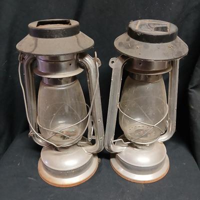 Two vintage kerosene lanterns adapted with solar lights