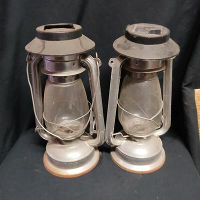 Two vintage kerosene lanterns adapted with solar lights