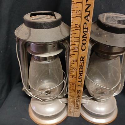 Two vintage kerosene lanterns adapted with solar lights