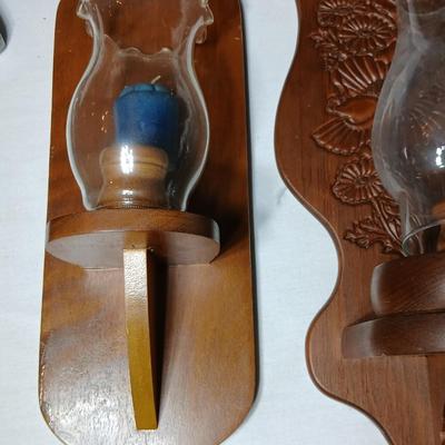 Three wooden wall hanging candle sconces with glass globes