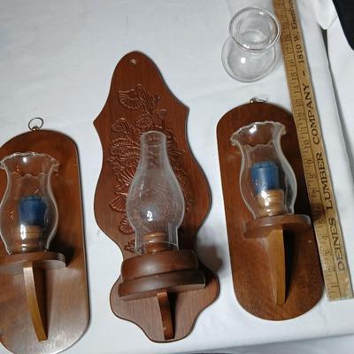 Three wooden wall hanging candle sconces with glass globes