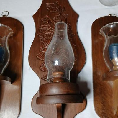 Three wooden wall hanging candle sconces with glass globes