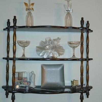 Wooden wall shelf with anniversary collectibles including pie and knife serving utensils