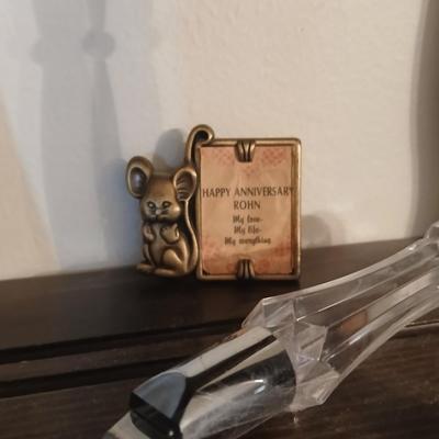 Wooden wall shelf with anniversary collectibles including pie and knife serving utensils