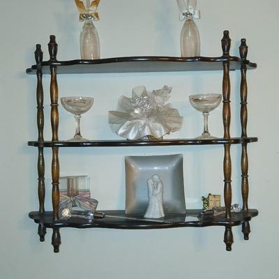 Wooden wall shelf with anniversary collectibles including pie and knife serving utensils