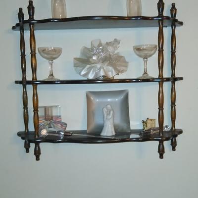 Wooden wall shelf with anniversary collectibles including pie and knife serving utensils