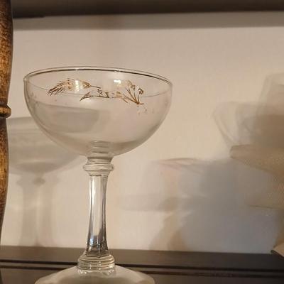 Wooden wall shelf with anniversary collectibles including pie and knife serving utensils
