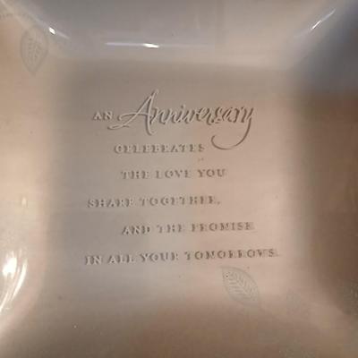 Wooden wall shelf with anniversary collectibles including pie and knife serving utensils