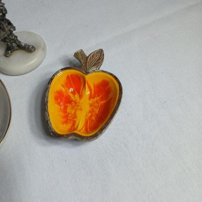 Two pewter clowns on marble bases with apple dish and small plate