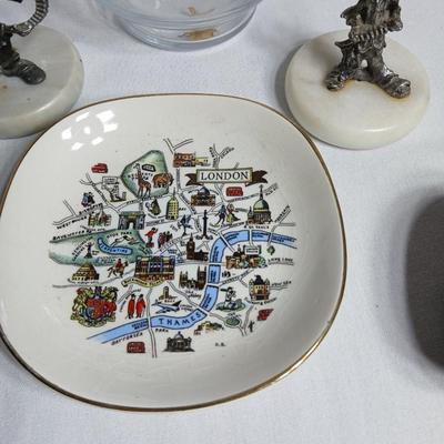 Two pewter clowns on marble bases with apple dish and small plate