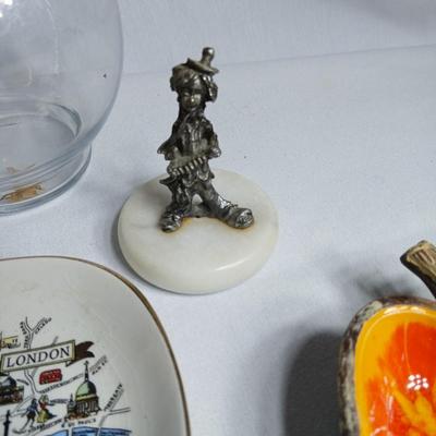 Two pewter clowns on marble bases with apple dish and small plate