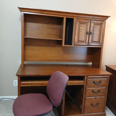 Golden Oak Desk with top hutch with two drawer keys and an office chair