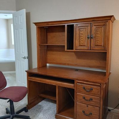 Golden Oak Desk with top hutch with two drawer keys and an office chair