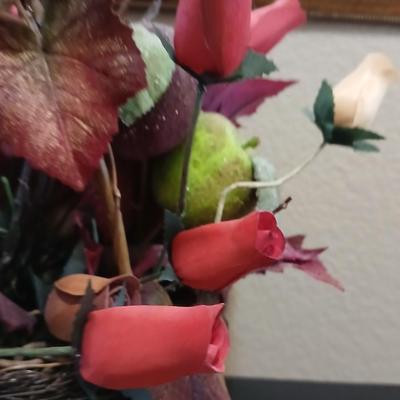Beautiful fall bouquet with wooden roses in a basket with a doiley